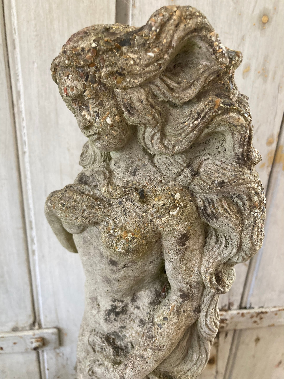 Stone garden statue of a lady, featuring aged patina and intricate details, perfect for outdoor elegance. Source for the Goose Devon.