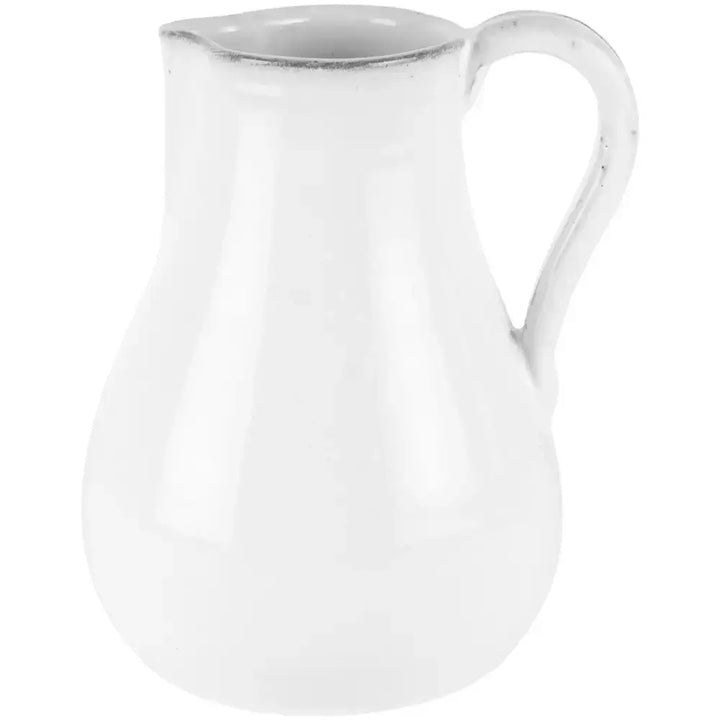 Vintage style glazed white jug with handle and spout, perfect for rustic home decor or serving beverages.