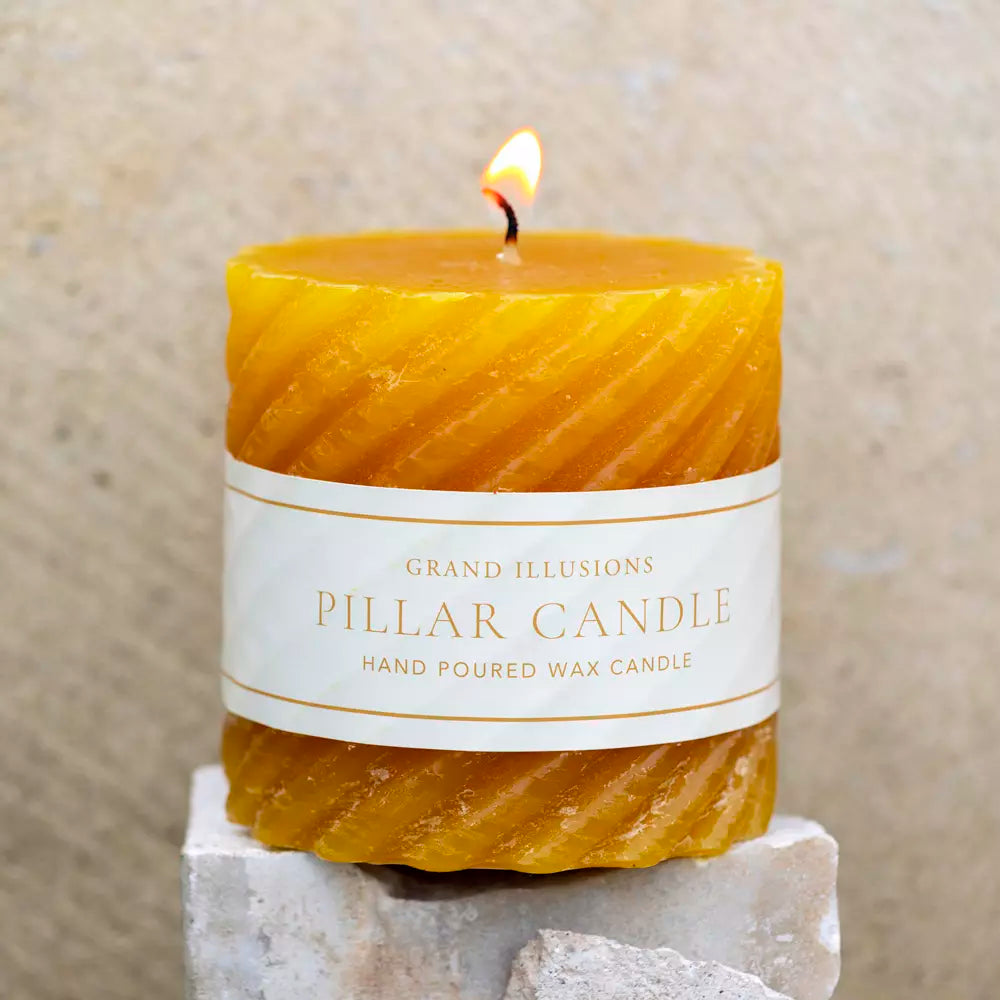 Twisted Warm Ochre Pillar Candle from Source for the Goose, hand-poured, elegant design with warm yellow glow.