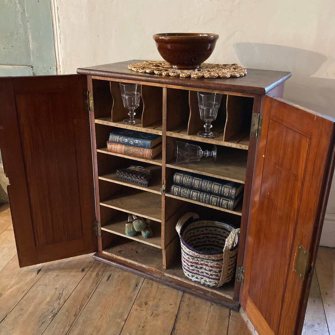 Vintage Pigeon Hole Cabinet with dark wood exterior, open doors revealing shelves and pigeon holes, styled with decorative items.